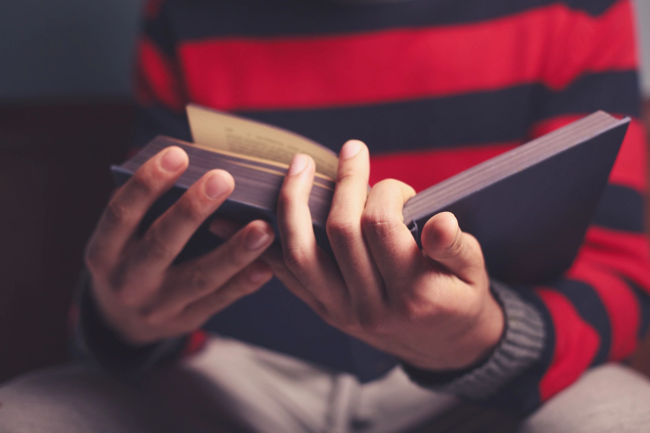 A young person reading a book